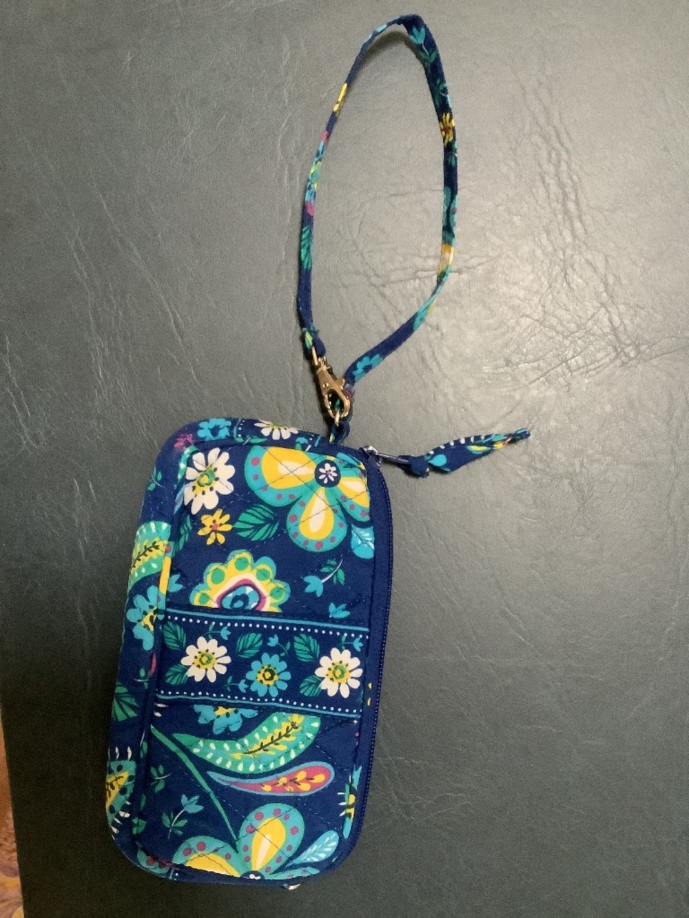 Blue flowered quilted wrist purse.